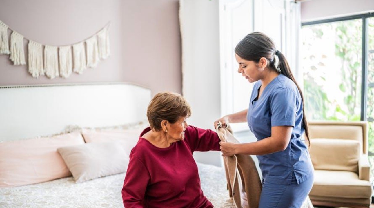 Caregiver helping a senior woman at home